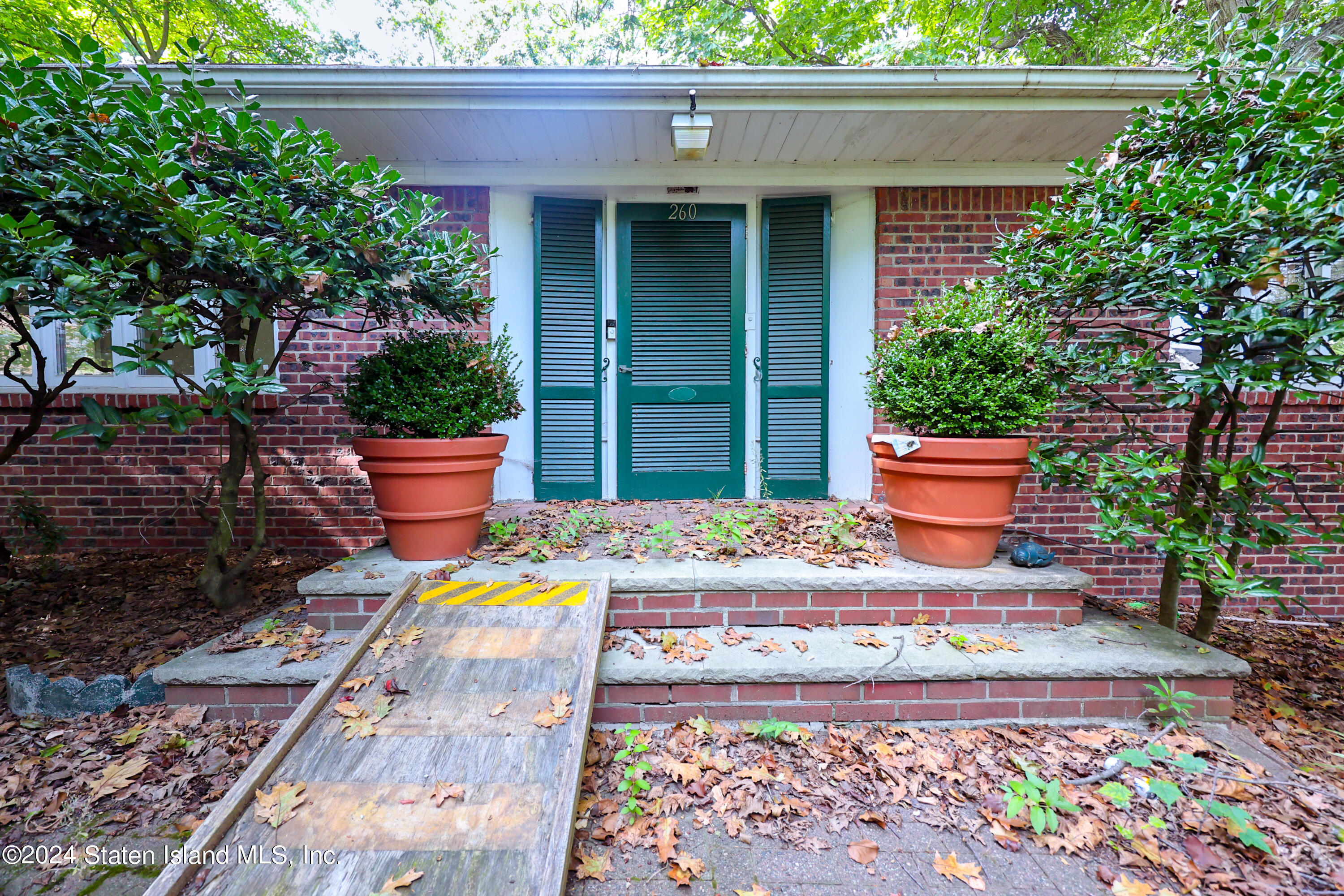 a front view of a house with fountain