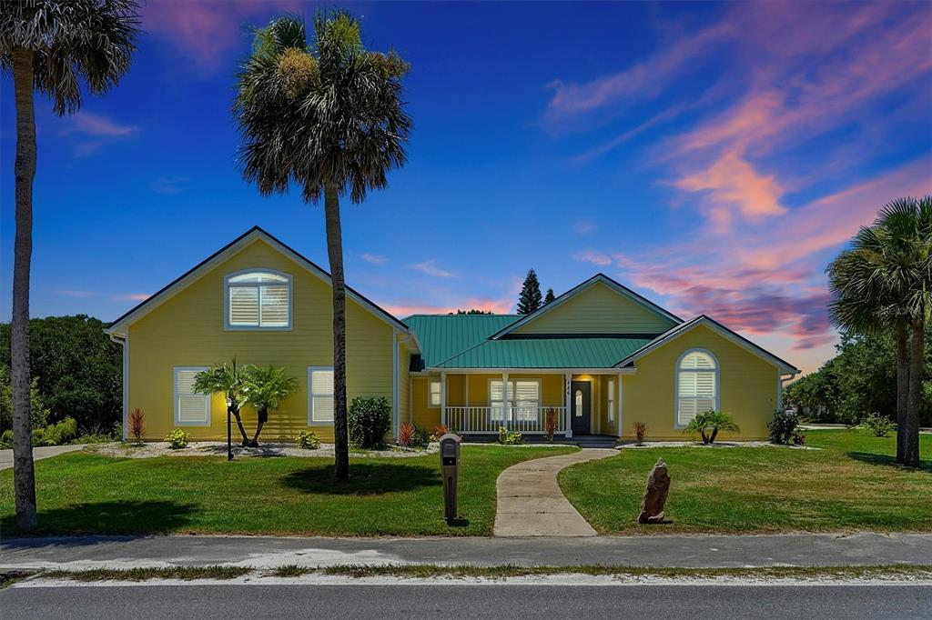 a front view of a house with a garden