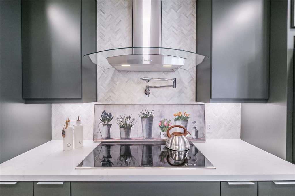 a kitchen with a sink and a mirror