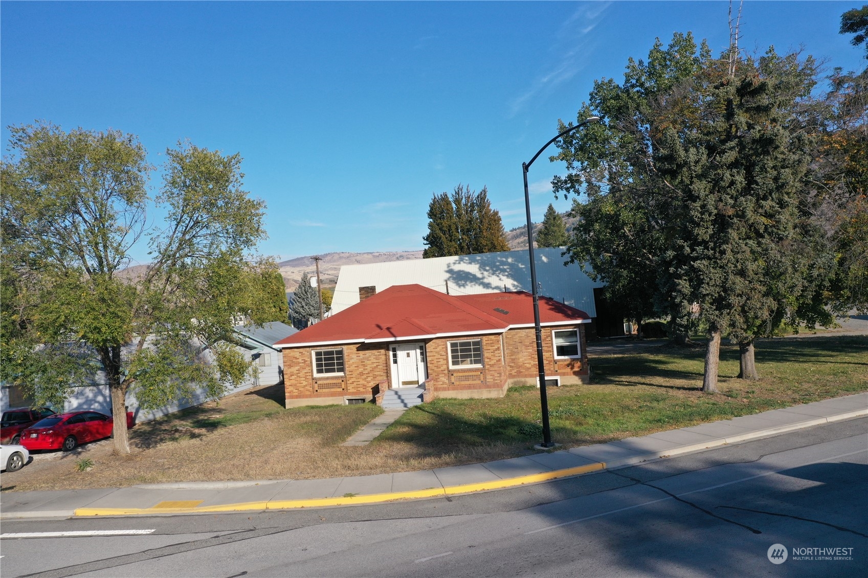 a front view of a house with a garden