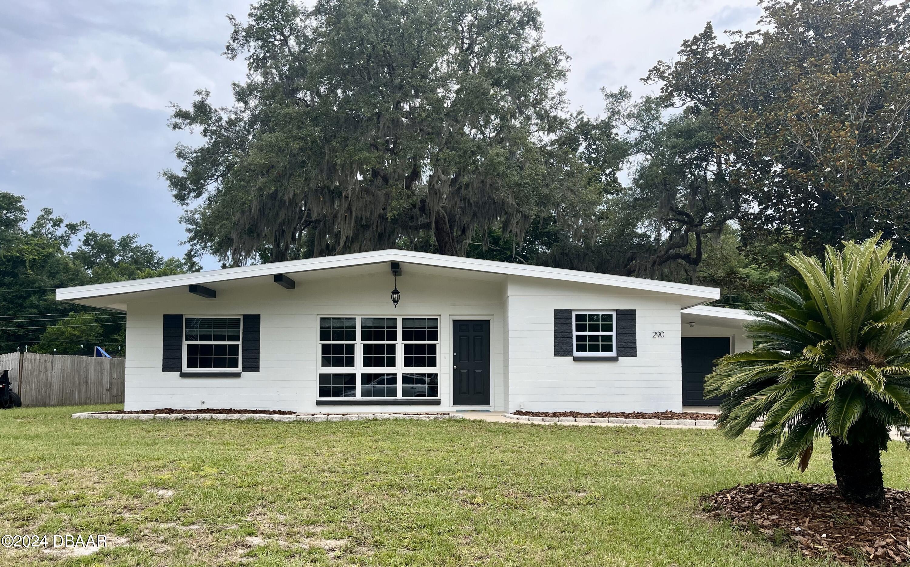 a house with a large window in front of a house