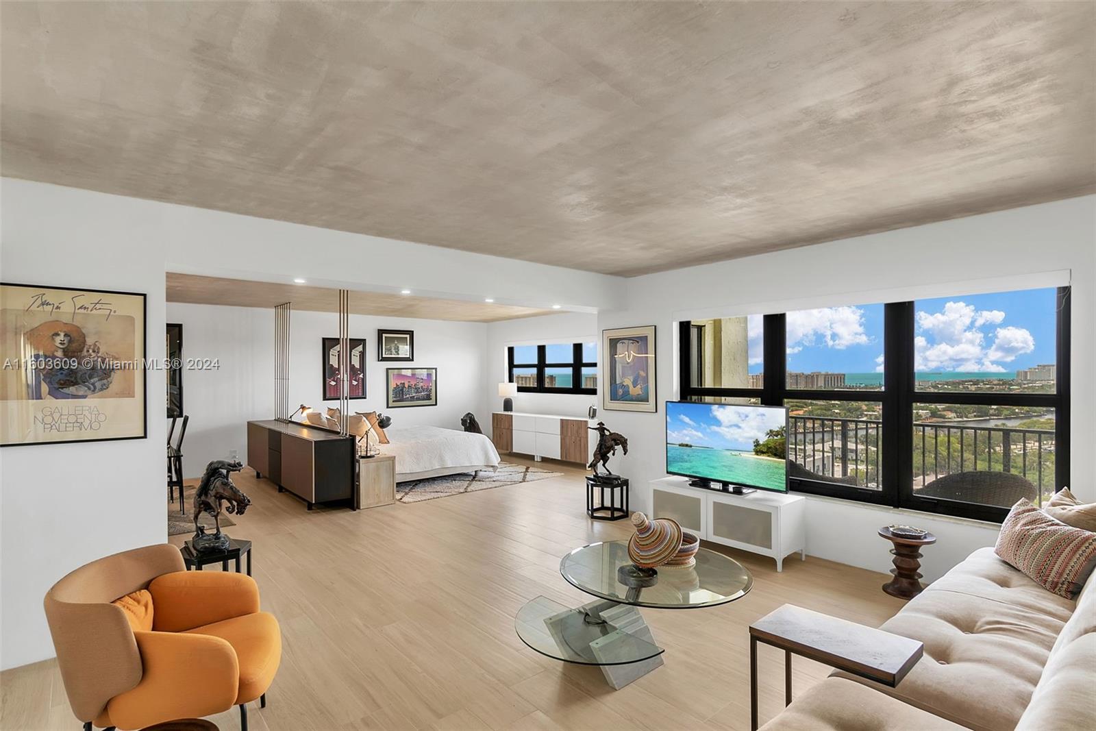 a living room with furniture and a floor to ceiling window