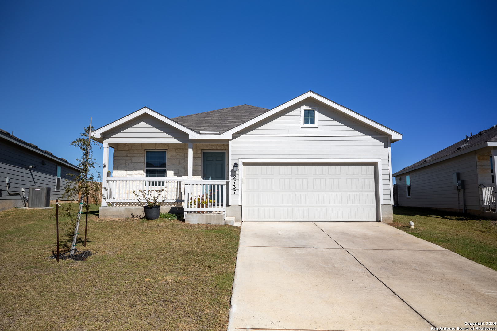 a front view of a house with a yard