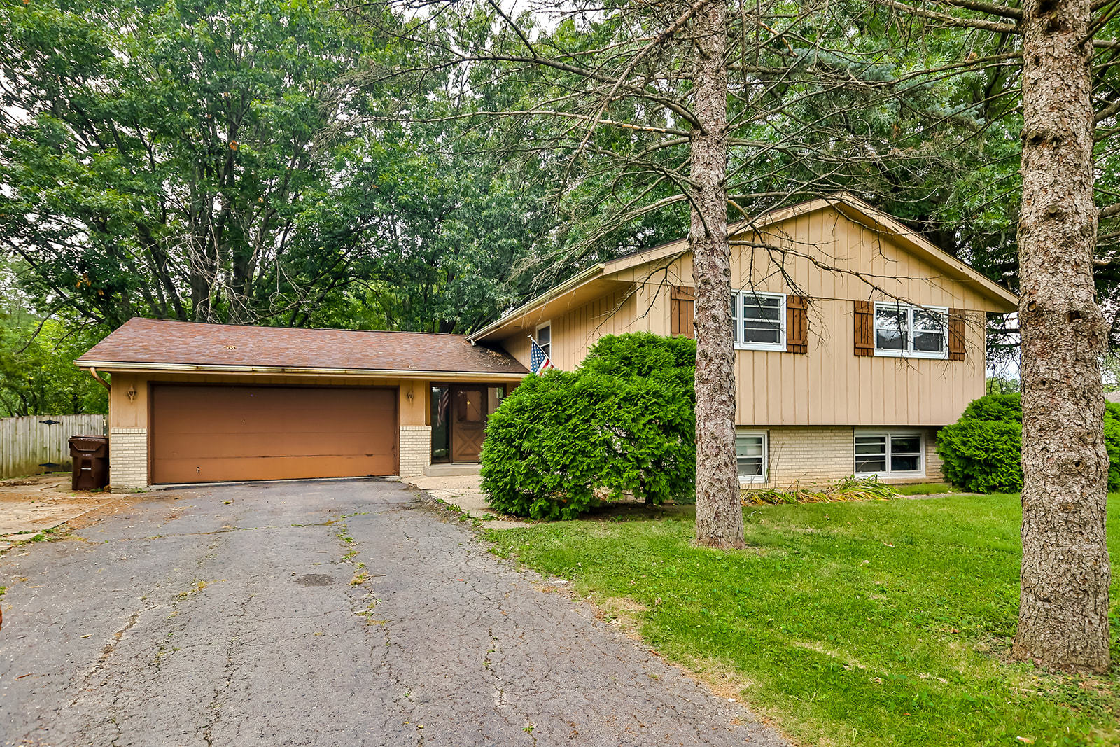 a front view of a house with a garden and yard