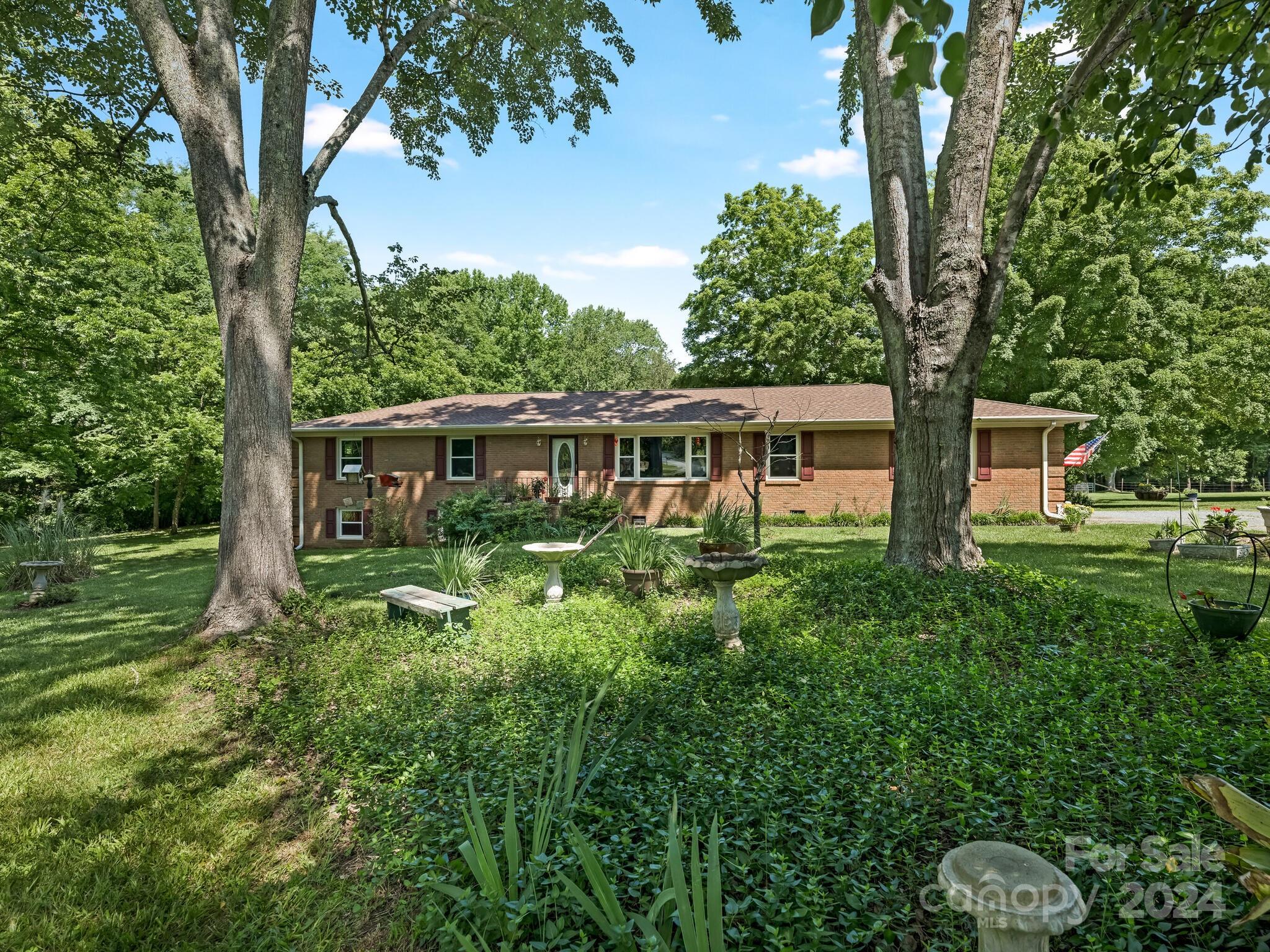 a front view of house with yard and green space