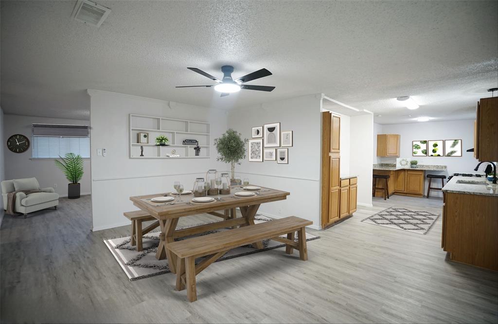 a living room with furniture and kitchen view