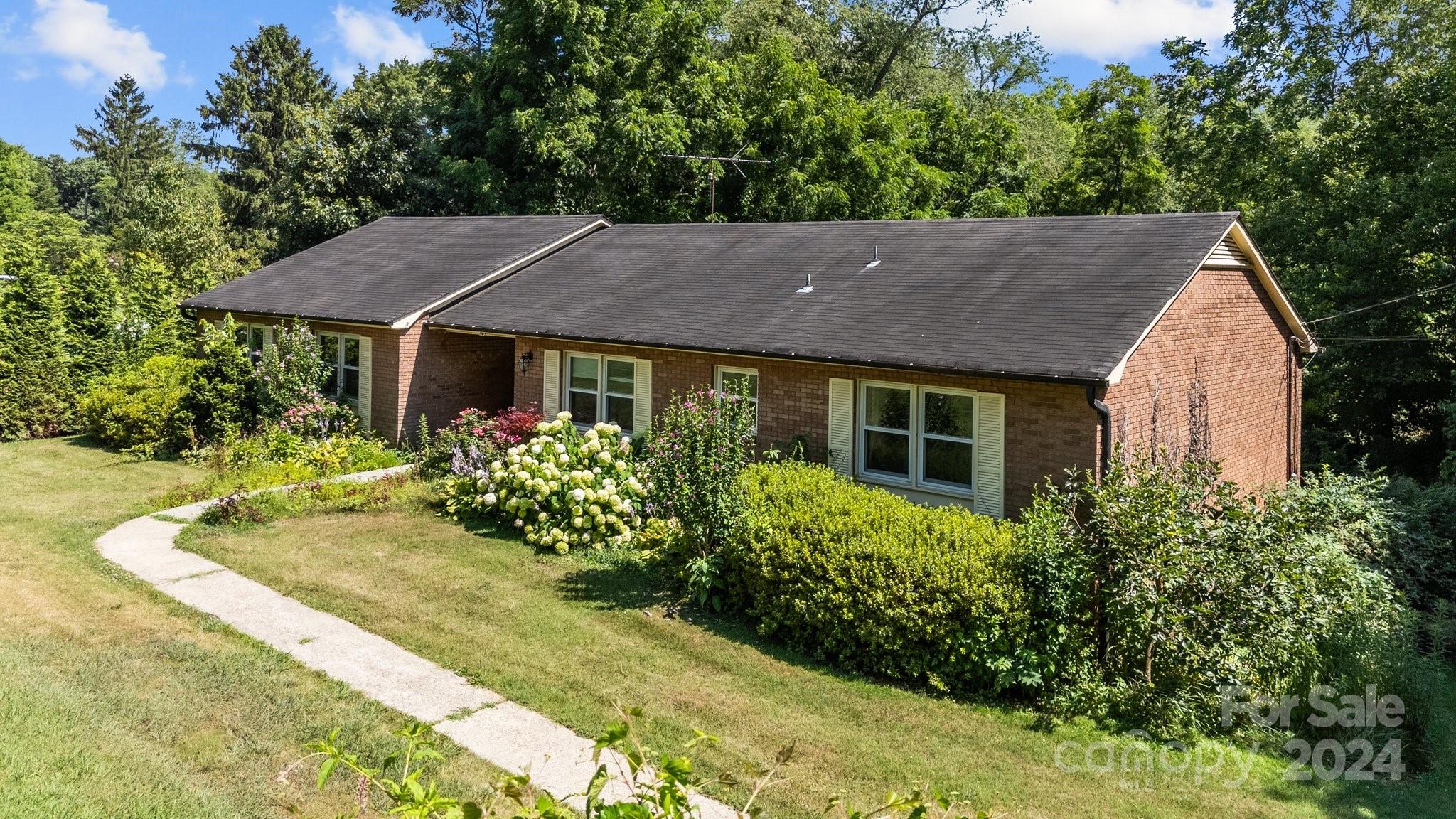 a aerial view of a house with a yard and potted plants