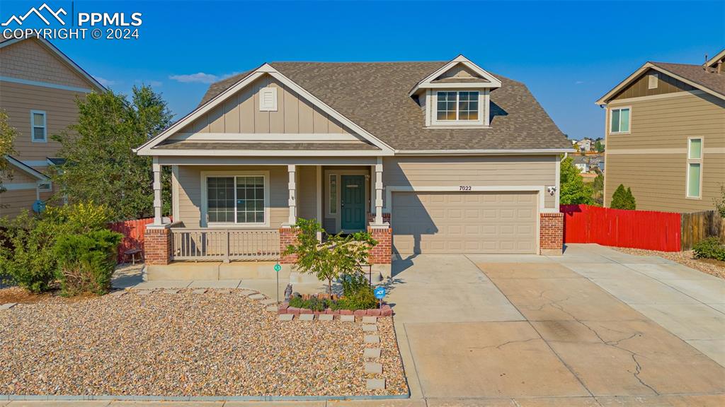 Craftsman-style home with a garage and a porch