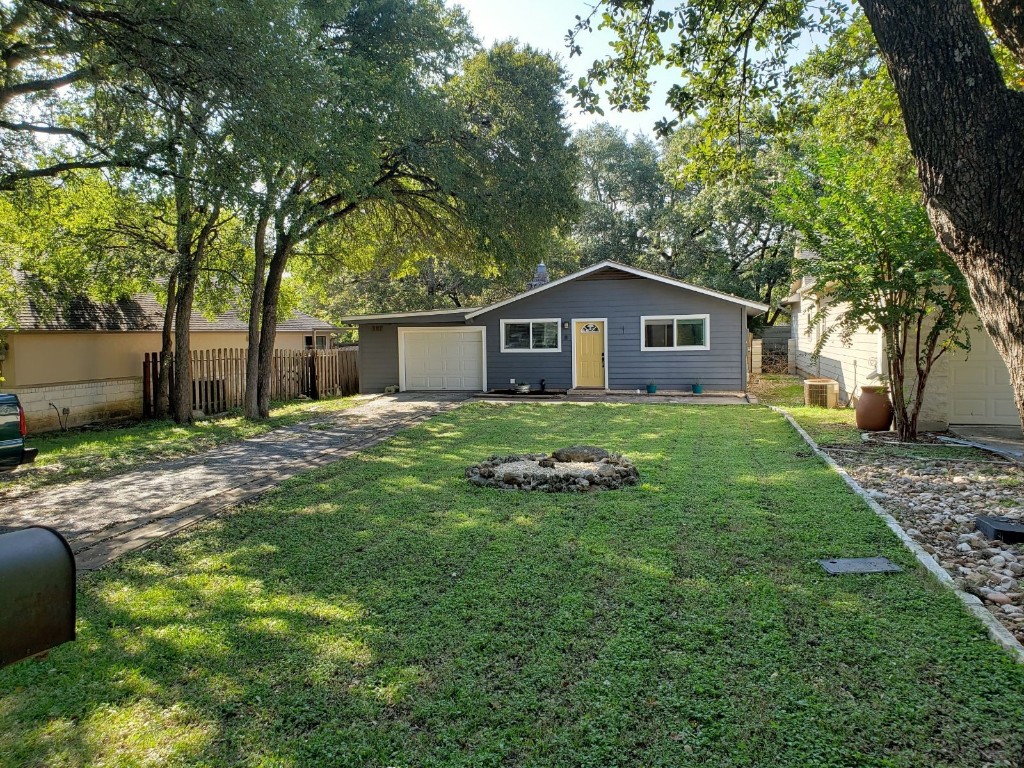 a front view of house with yard and green space