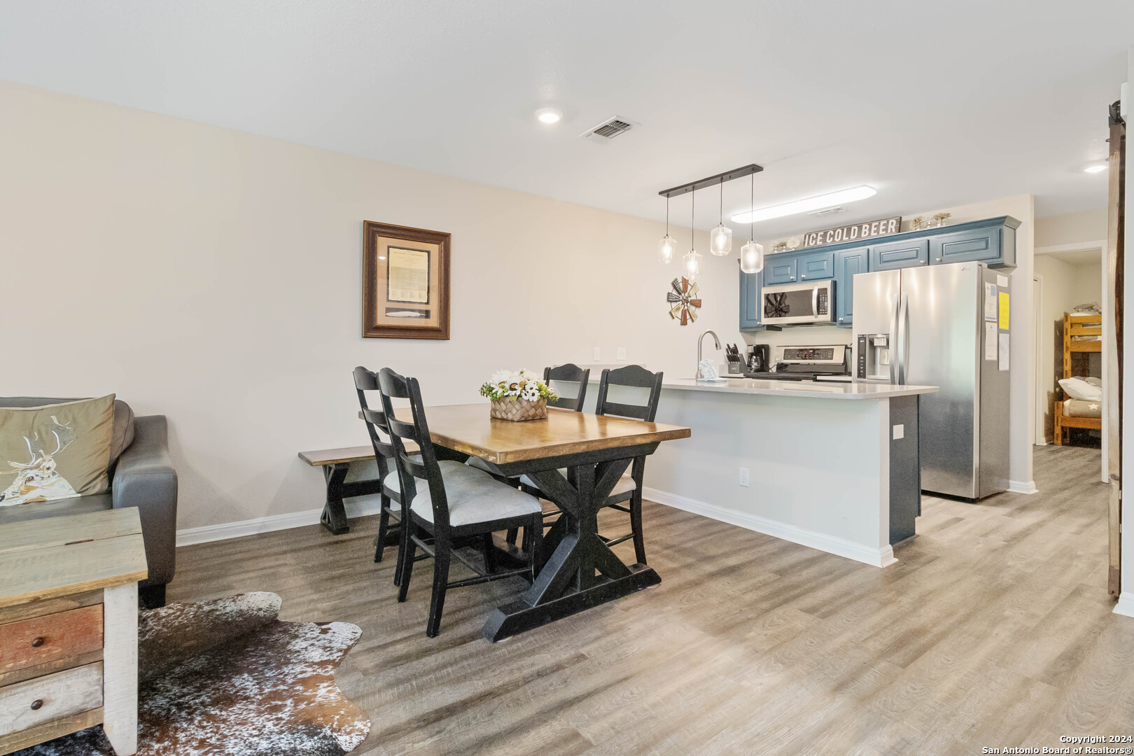 a view of a dining room with furniture and wooden floor