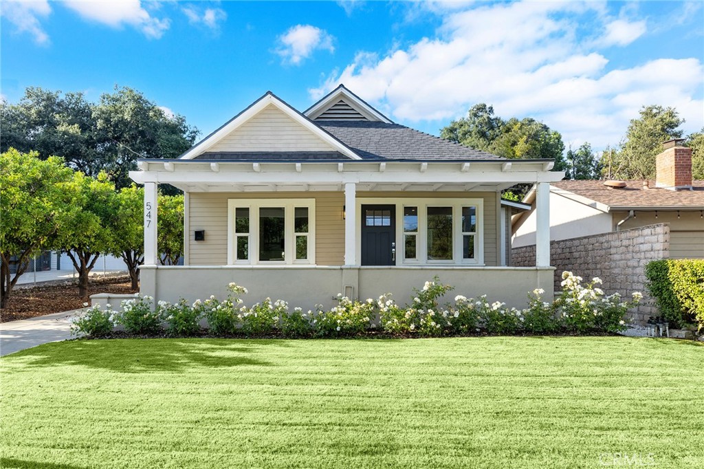 a front view of a house with a garden