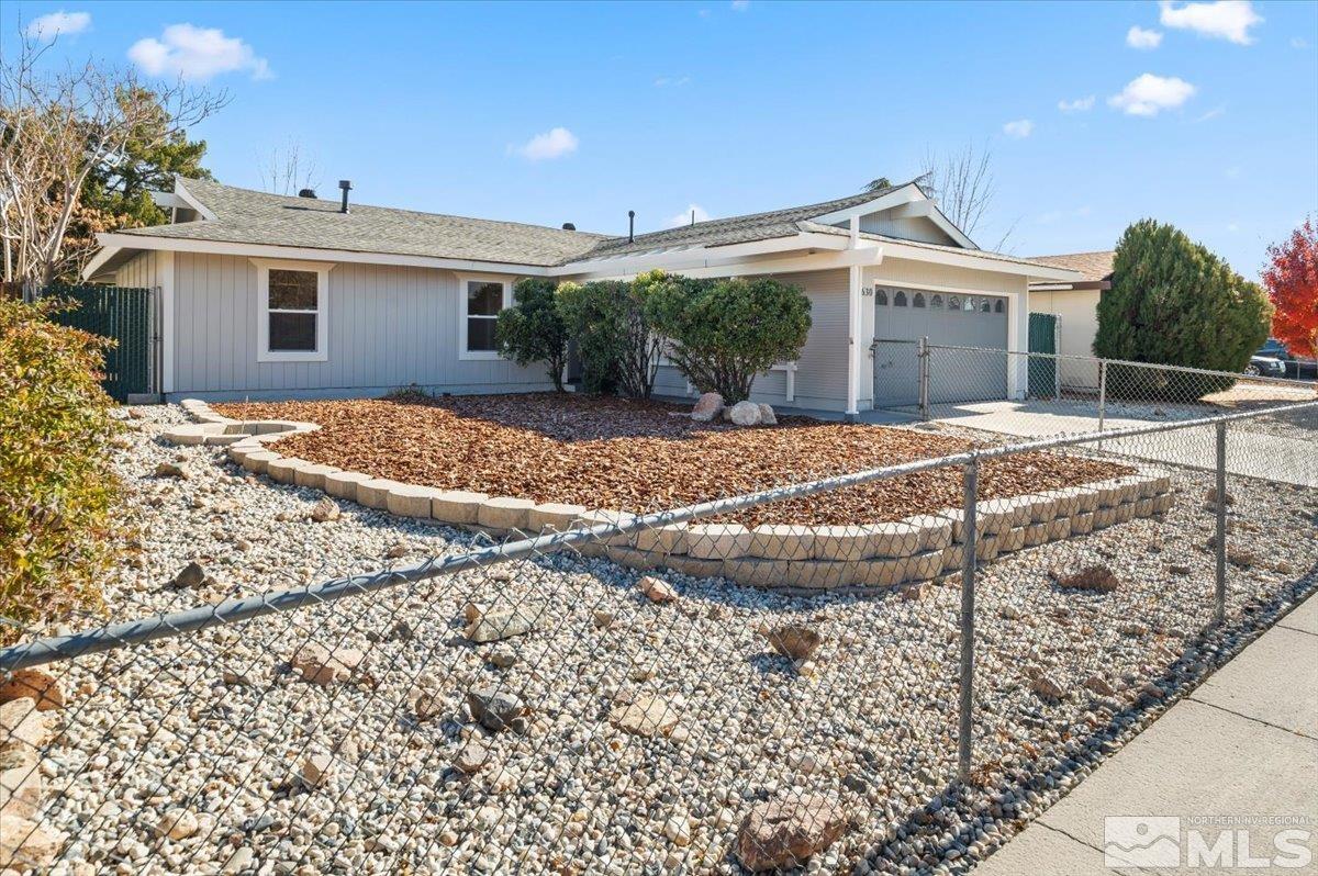 a view of a house with a yard and sitting area