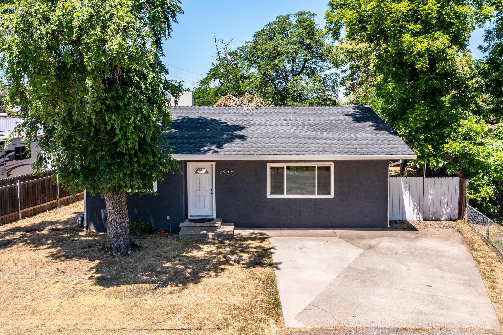 a house that has a tree in front of it