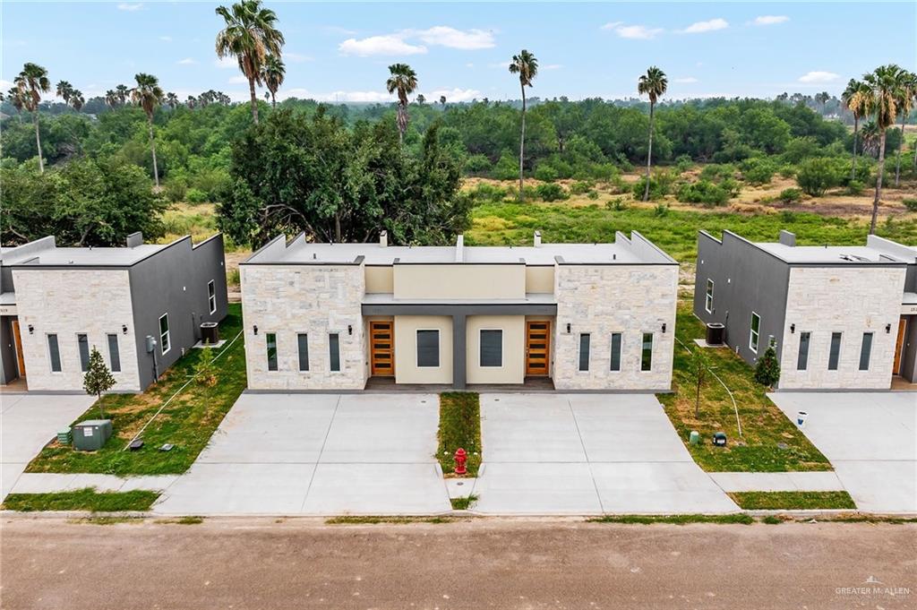 an aerial view of a house with a yard and potted plants