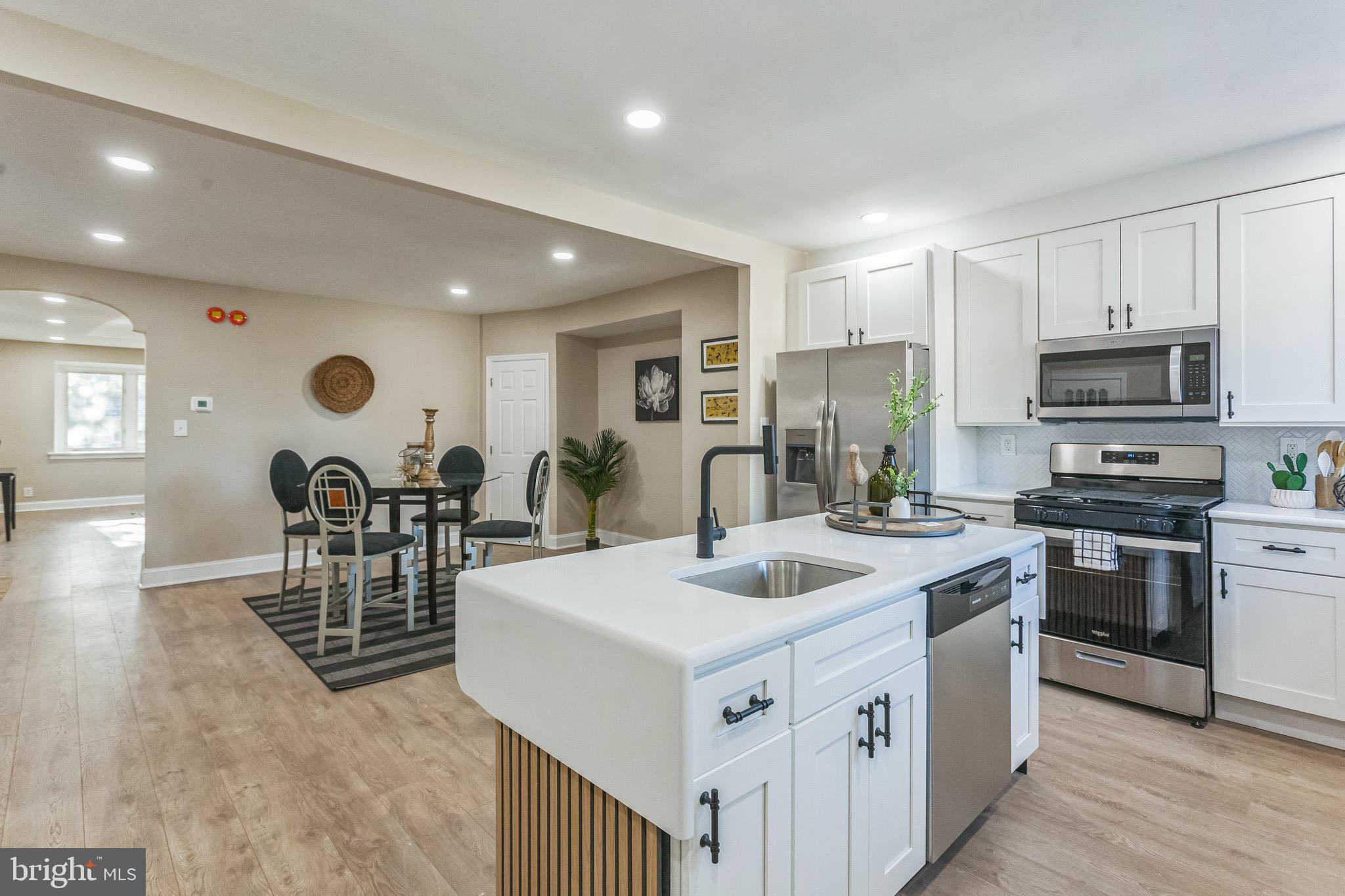 a view of kitchen with sink microwave and stove