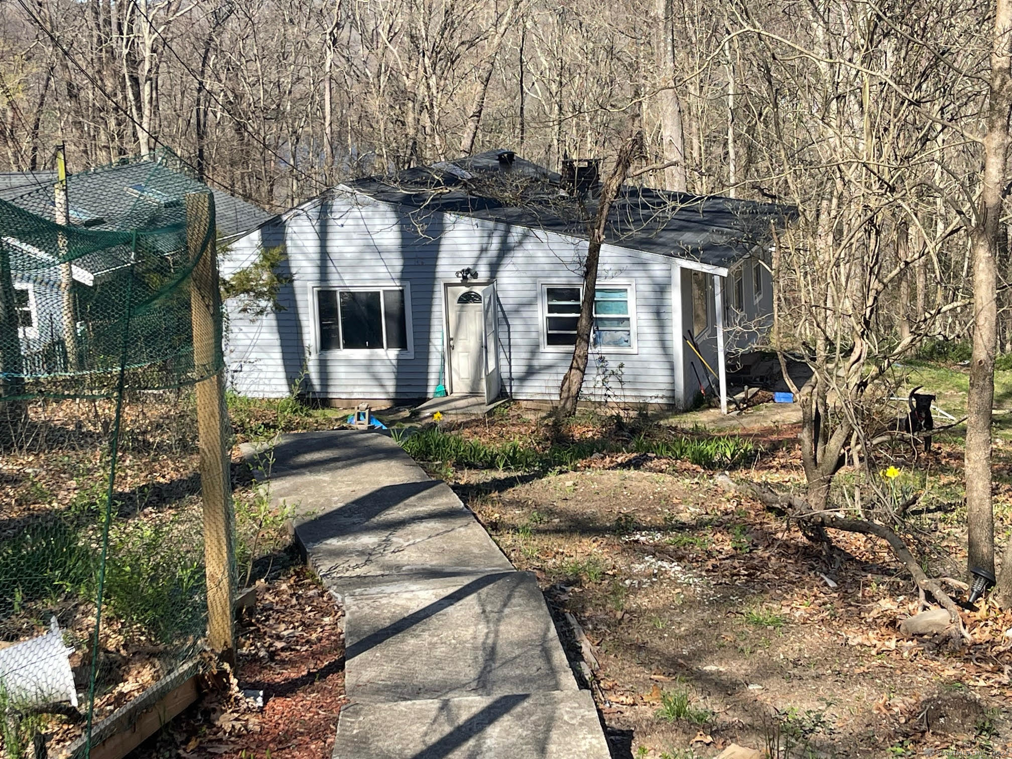 a view of a house with yard and sitting area