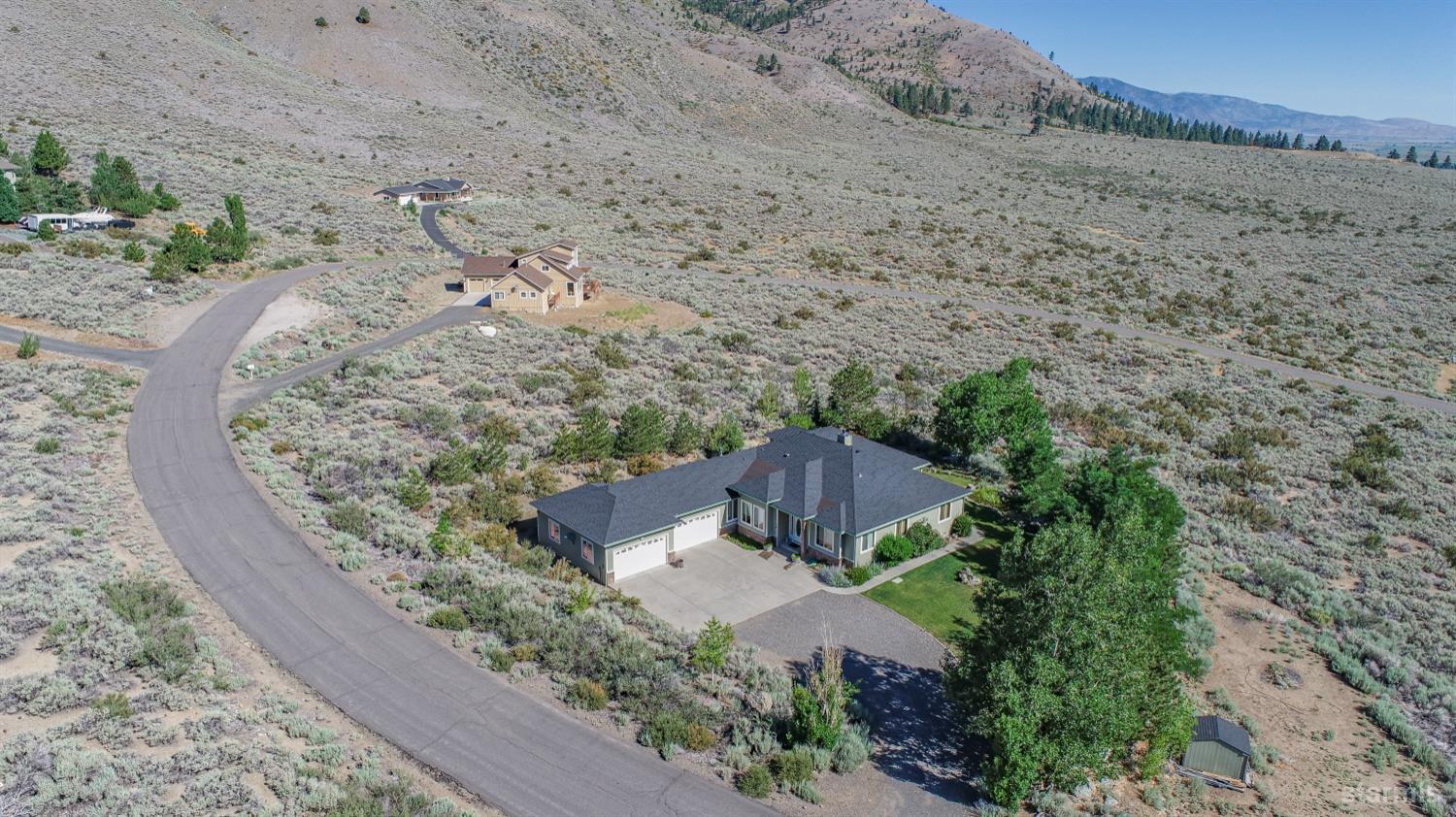 an aerial view of a house with a yard