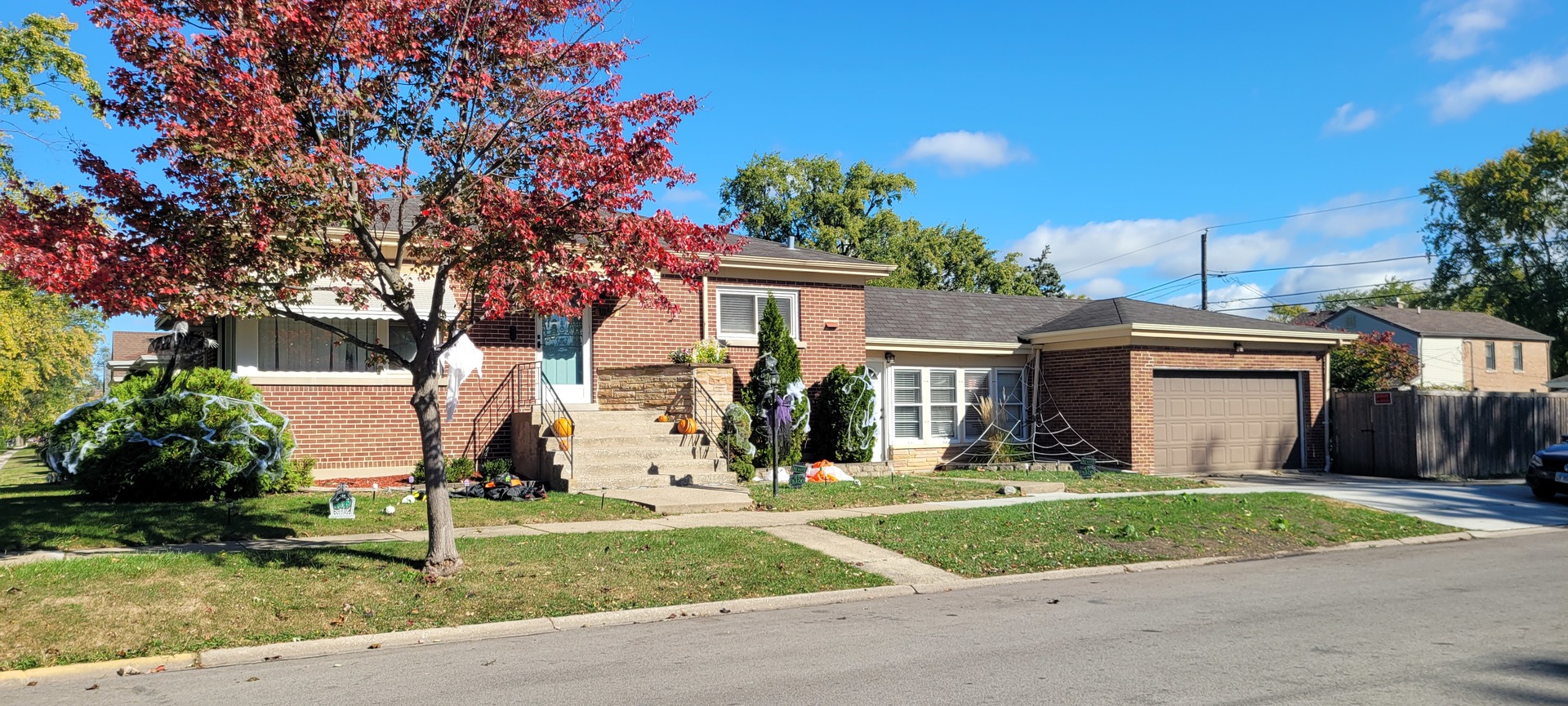 a front view of house with yard and green space