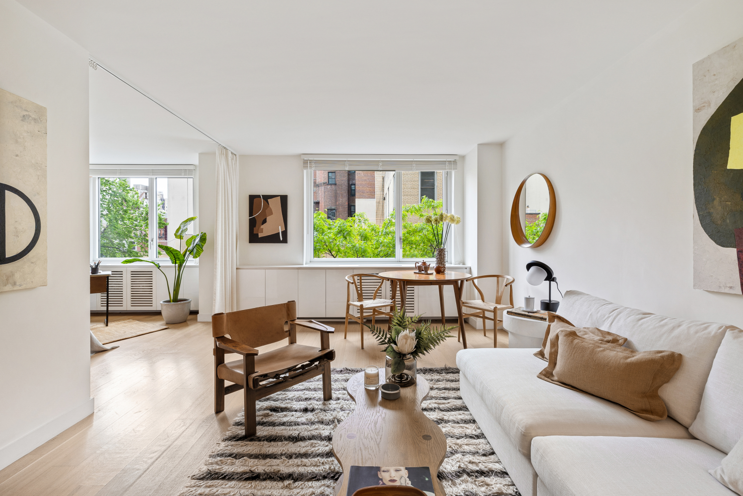 a living room with furniture a chandelier and a window