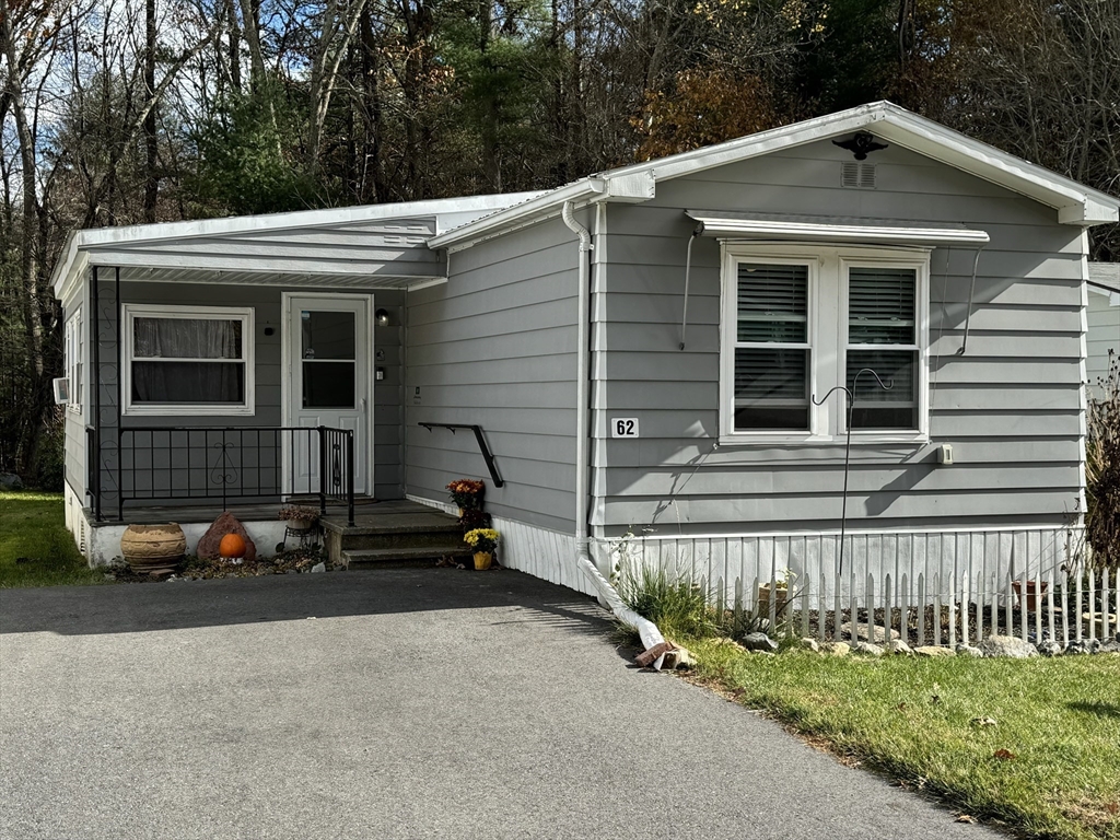 a view of a house with yard and sitting area