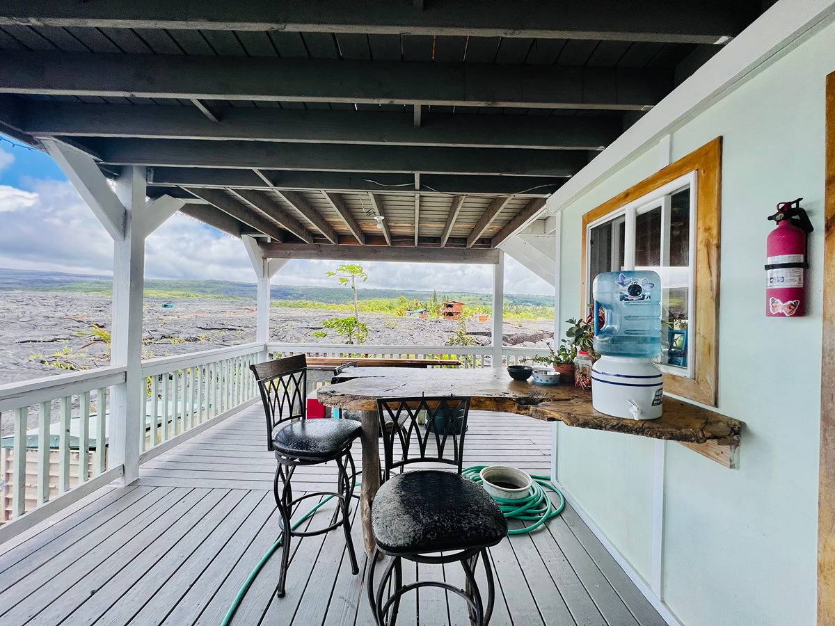 a view of a chairs and table in the balcony