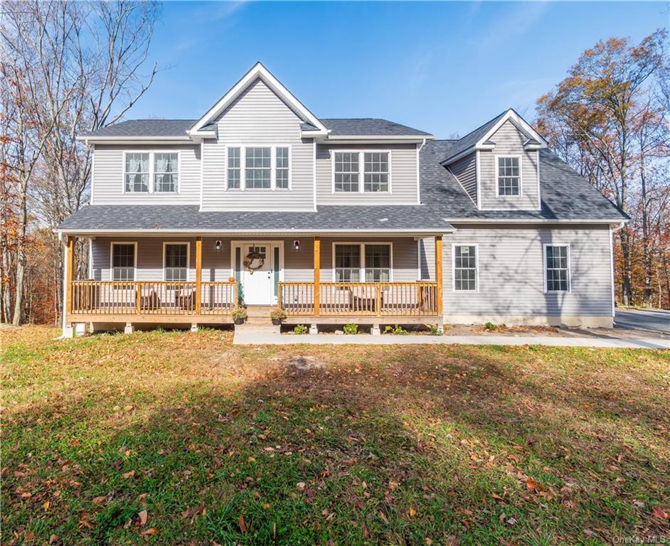 a front view of a house with yard and deck