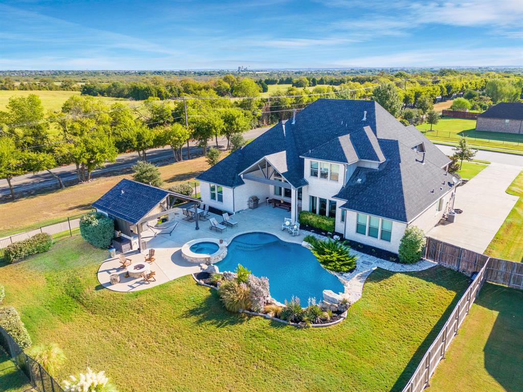 an aerial view of residential houses with outdoor space and ocean view