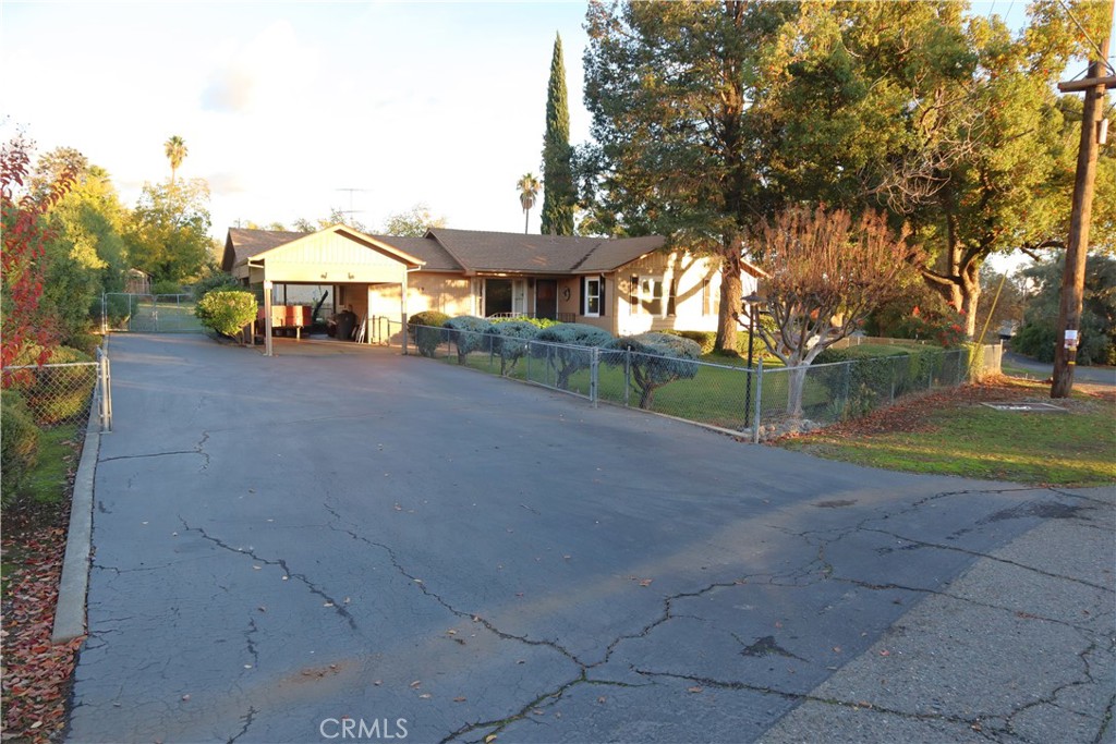 a view of a house with a yard and tree s