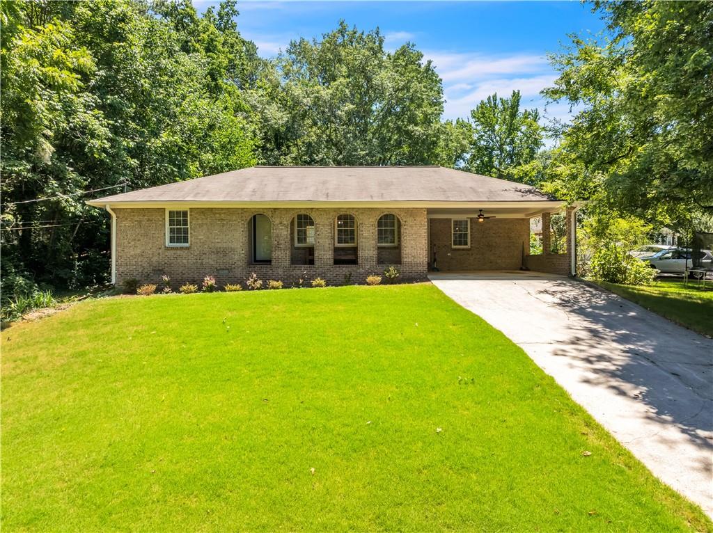 a front view of house with yard and green space