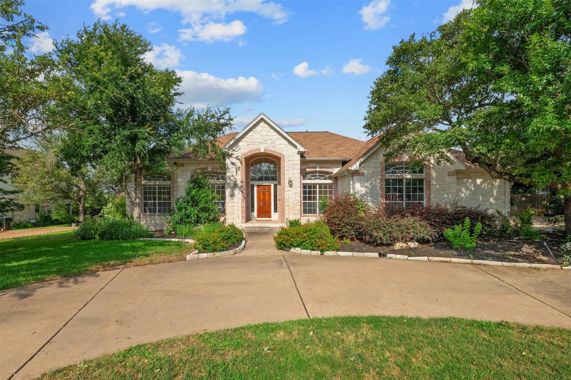 a front view of a house with a yard and a garage