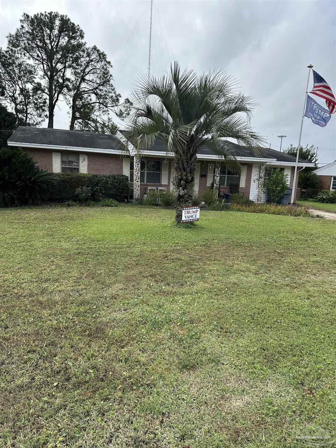 a front view of a house with a garden