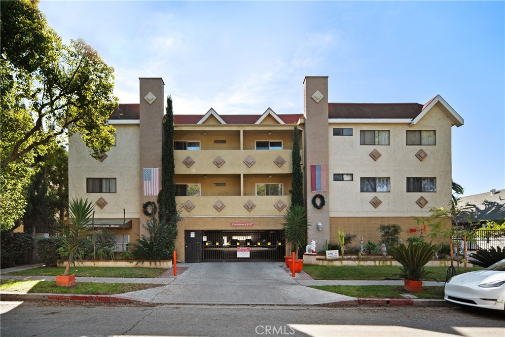 a front view of a residential apartment building with a yard