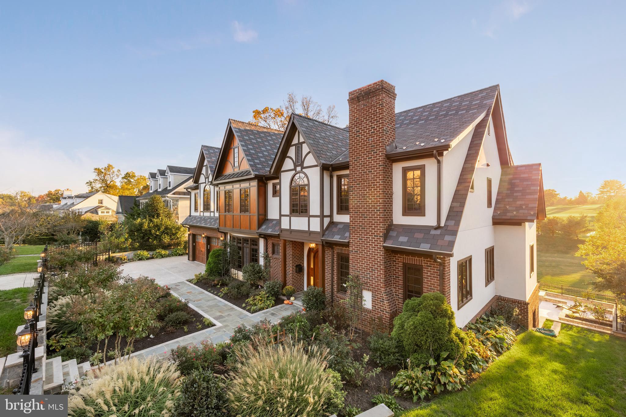 a front view of a house with a yard and outdoor seating