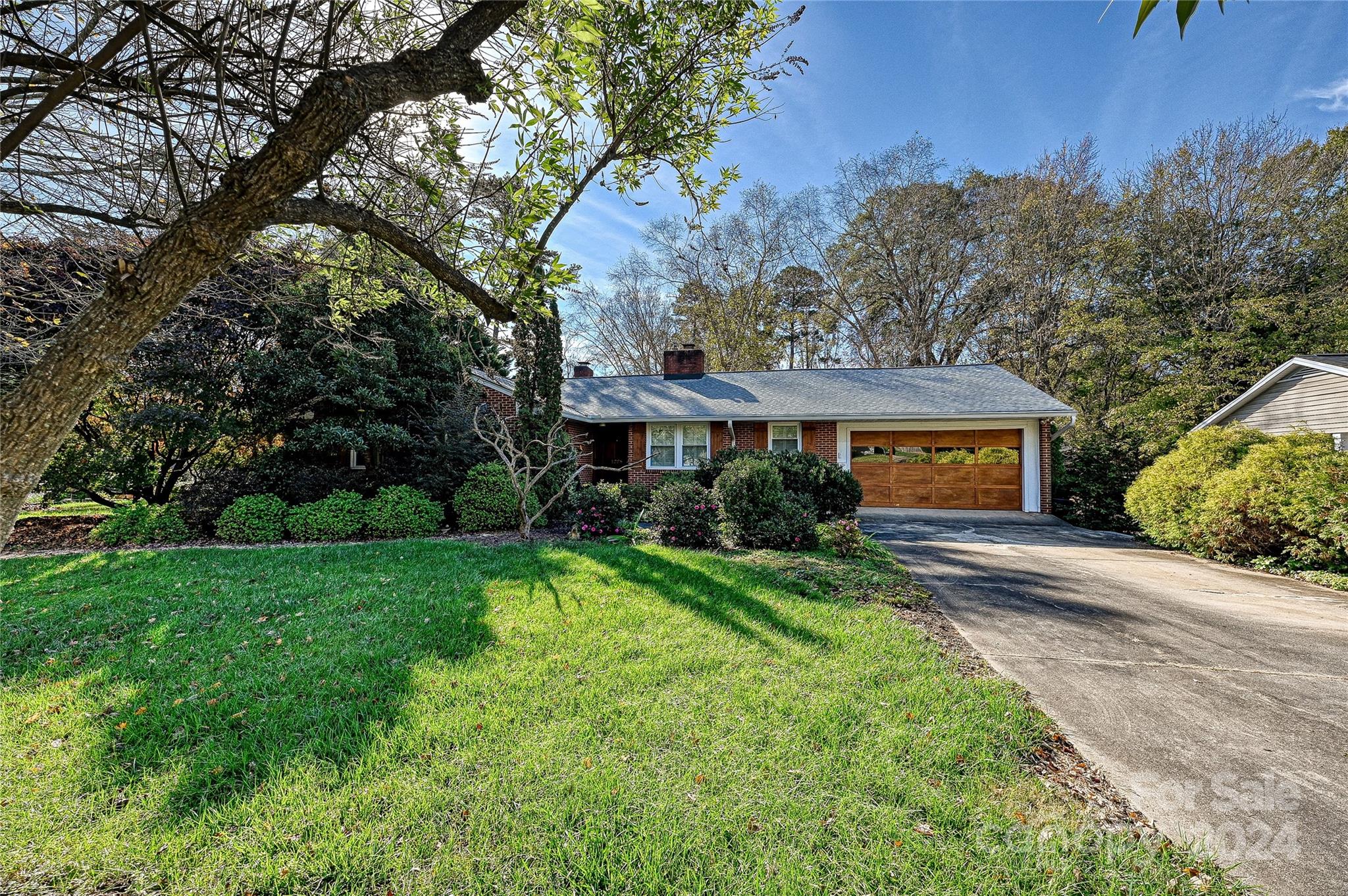 a front view of house with yard and trees