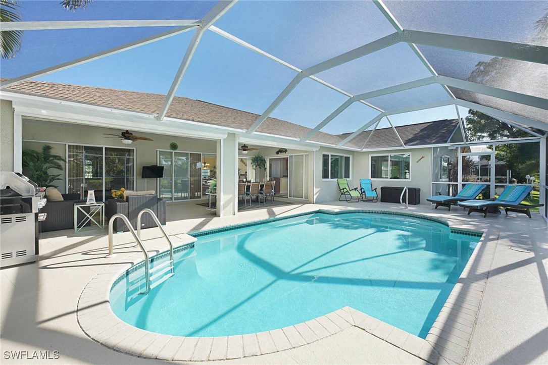 a view of a swimming pool with outdoor seating