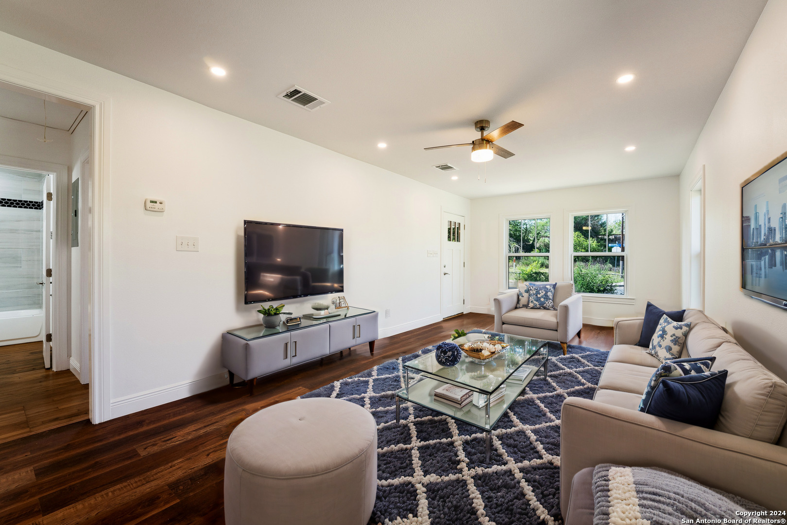 a living room with furniture and a flat screen tv