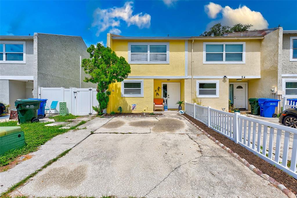 a view of a house with a small yard and plants