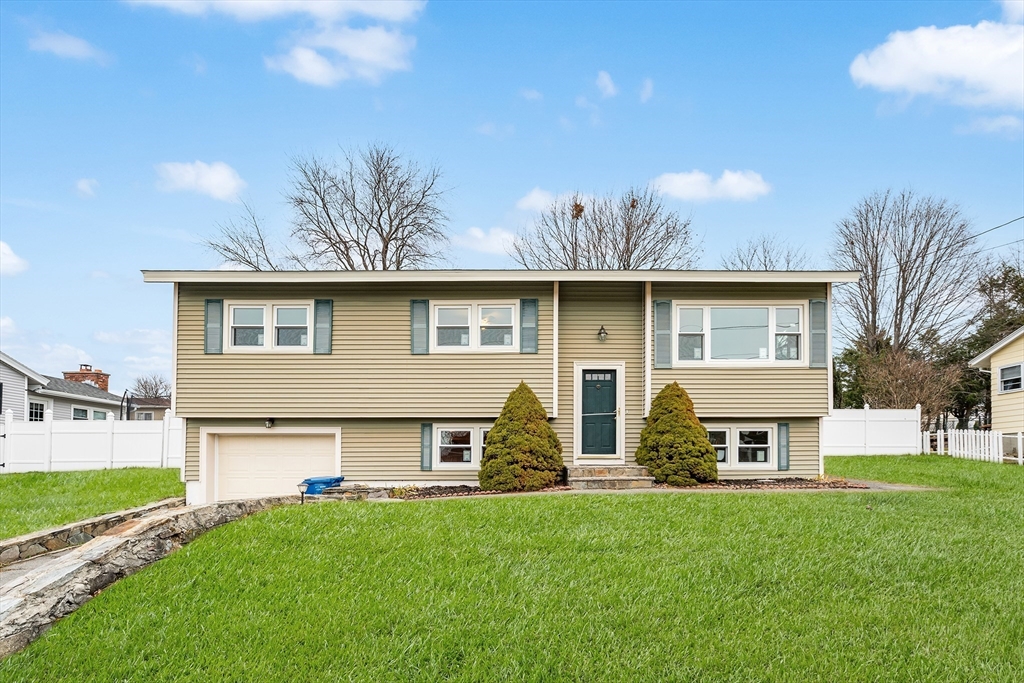 a front view of house with yard and outdoor seating