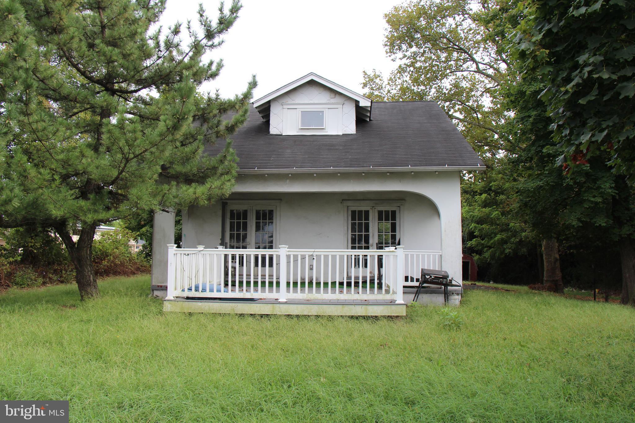 a view of a house with a yard and deck