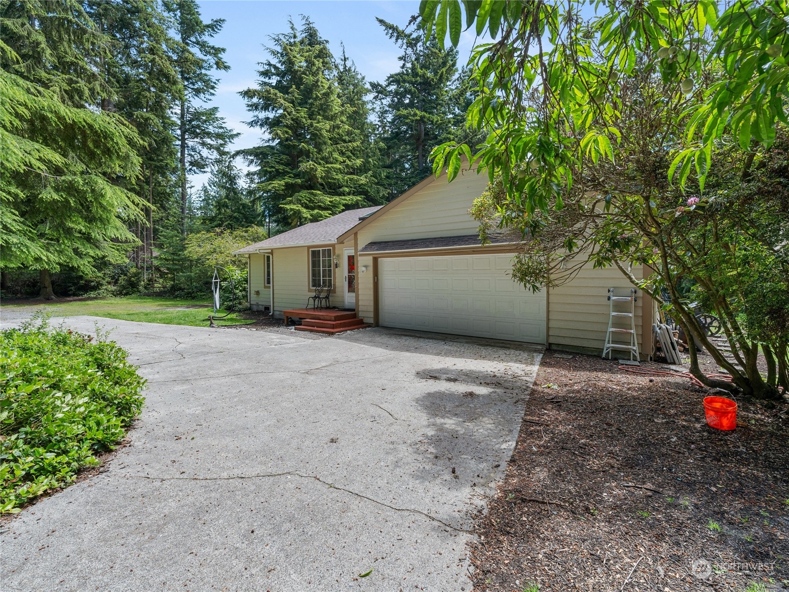 a view of a house with a yard and garage