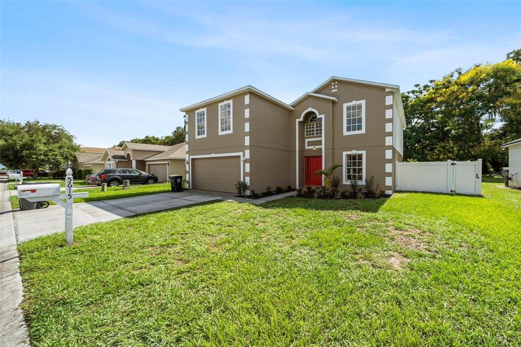 a front view of house with yard and green space