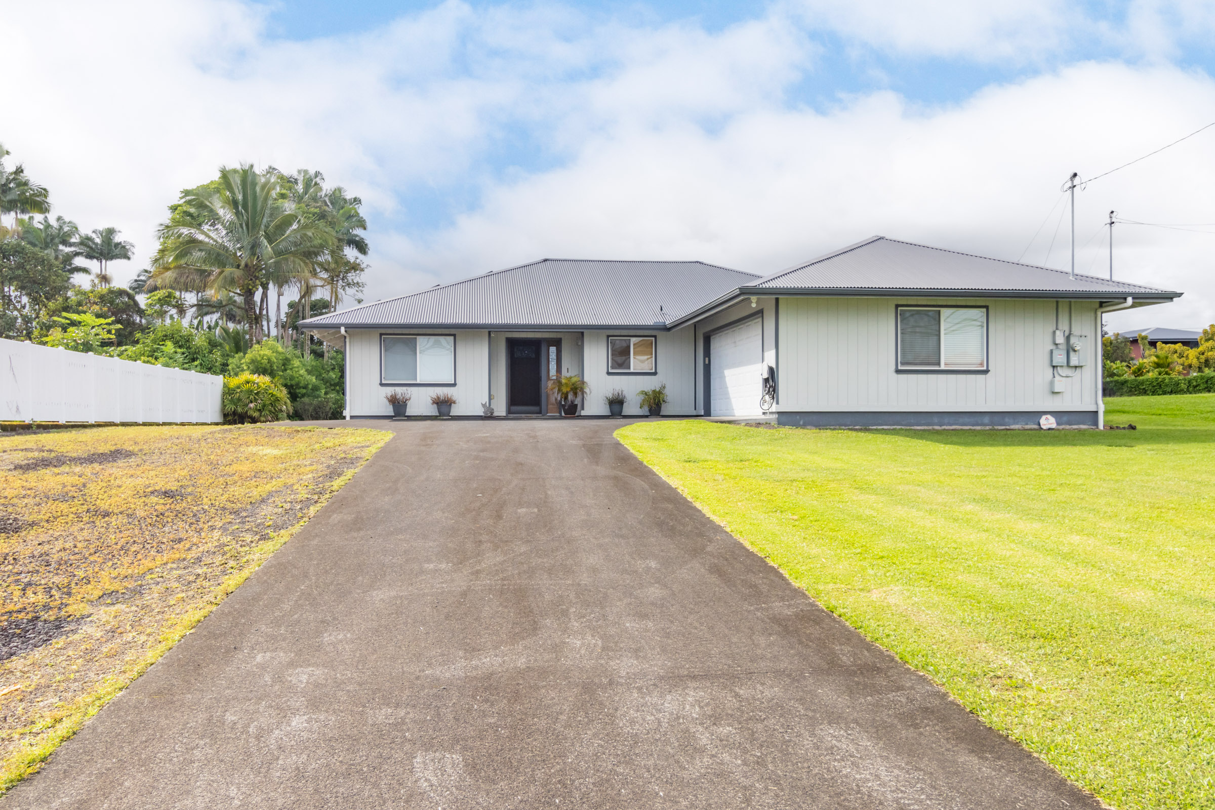 a front view of house with yard and trees