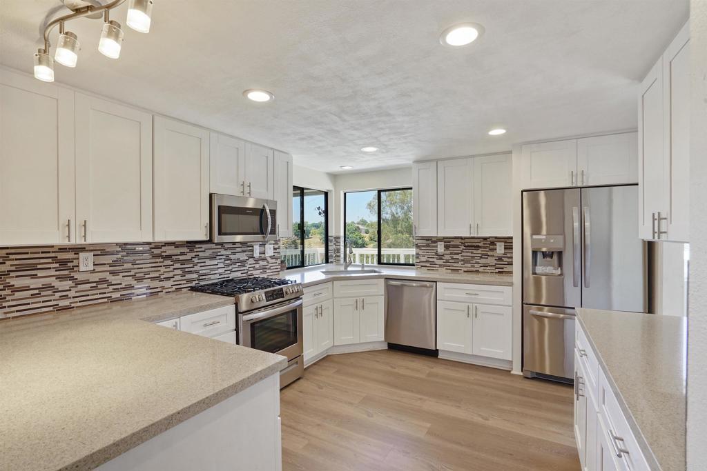 a kitchen with a refrigerator stove and sink