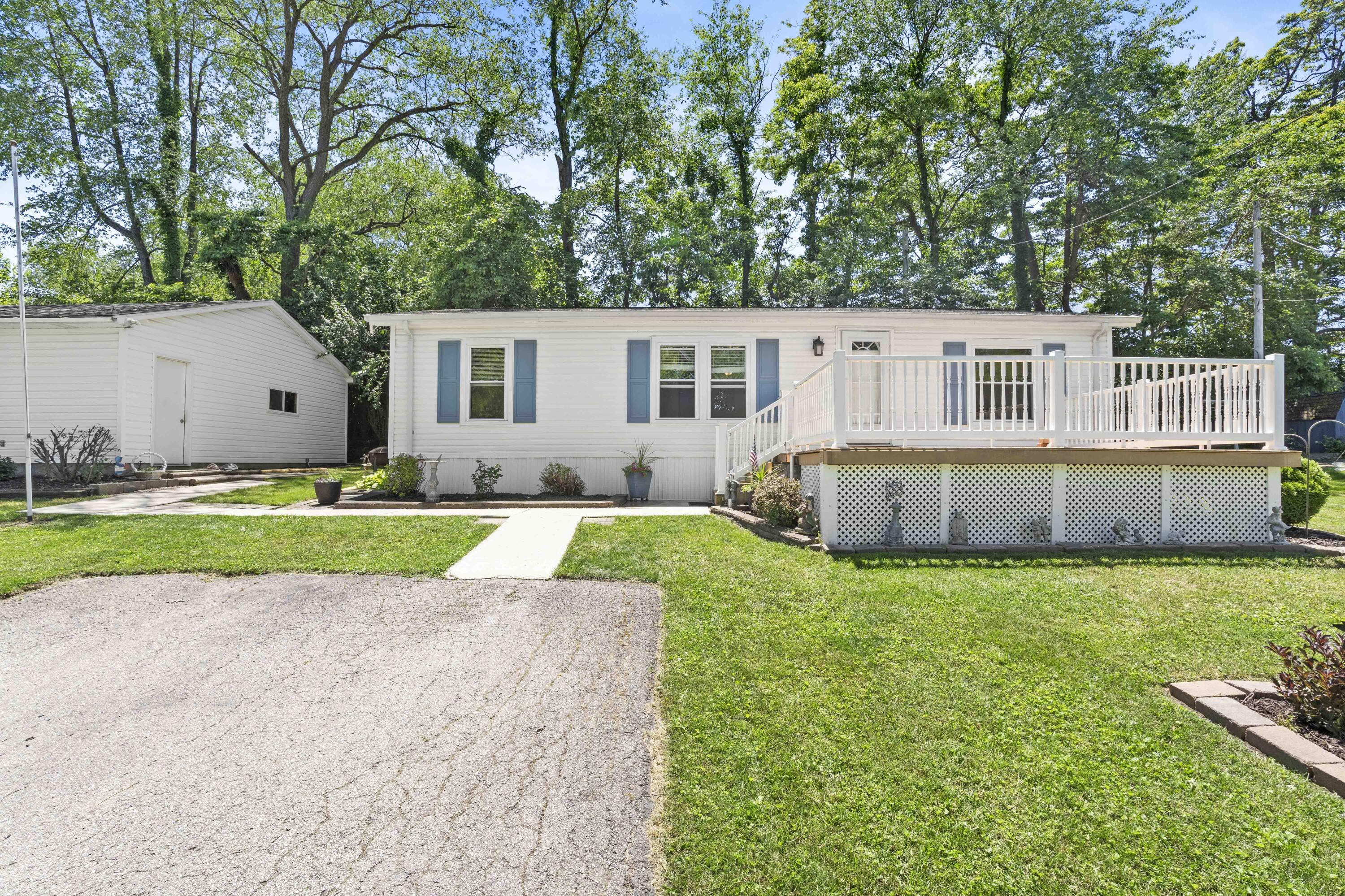 a view of house with backyard and trees