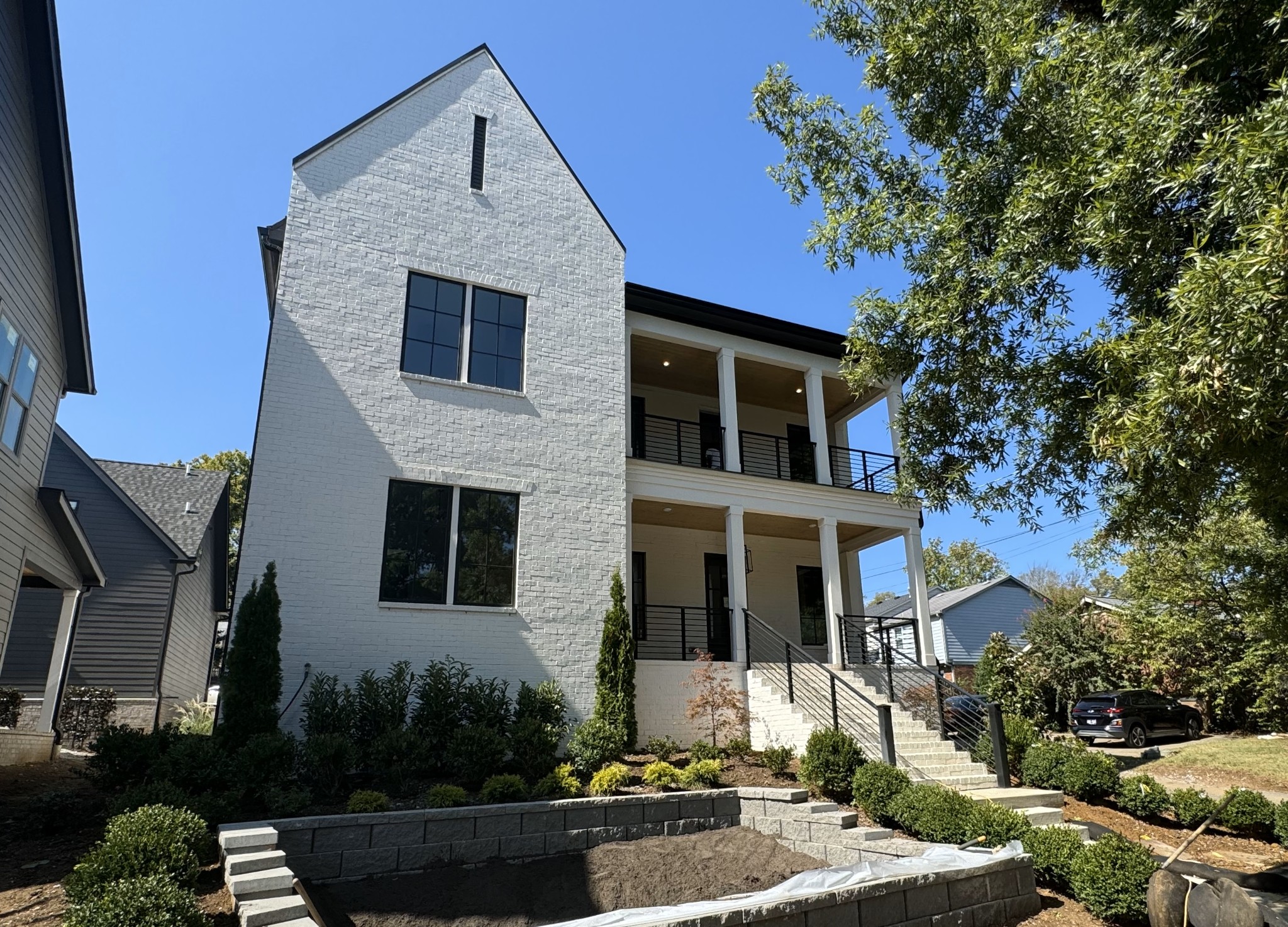 This beautiful home features a classic plantation-style covered porch and an upper balcony, perfect for enjoying outdoor living year-round.