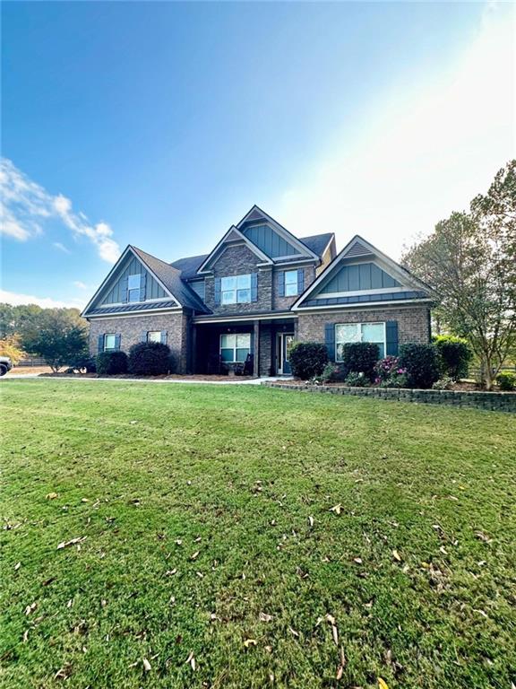 a front view of a house with a garden and trees