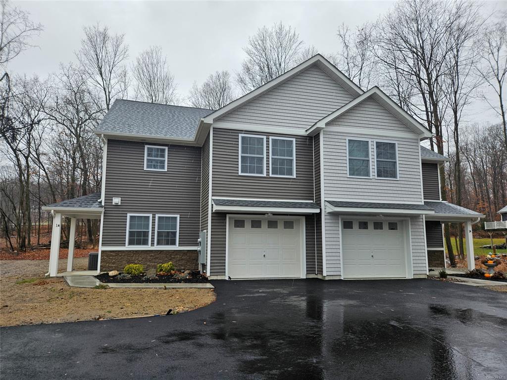 View of front of property featuring a garage