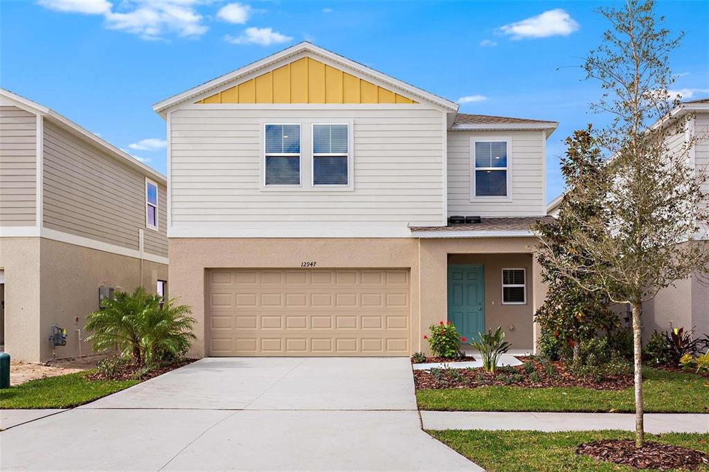 a front view of a house with a yard and garage