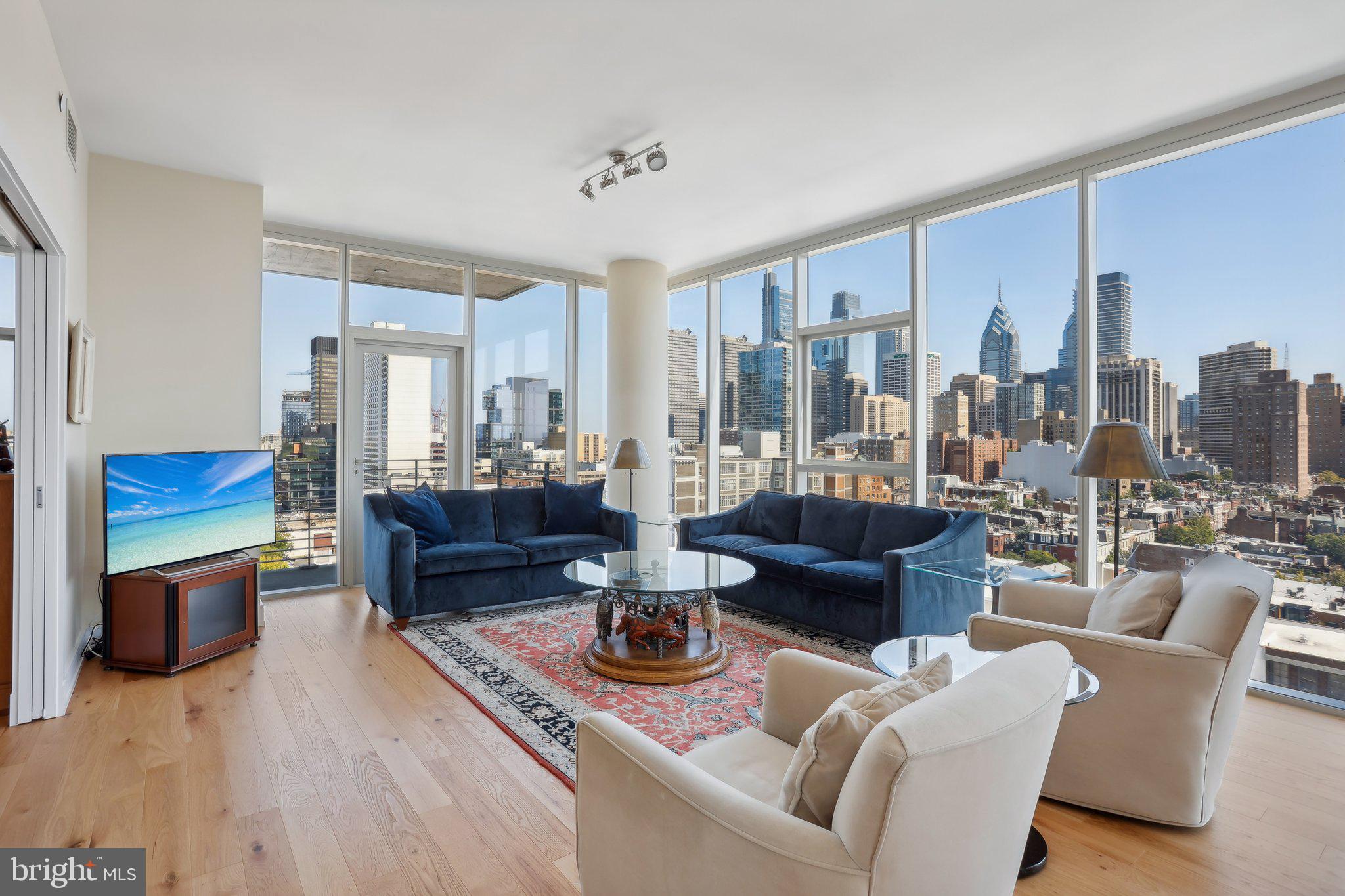 a living room with furniture and a view of kitchen