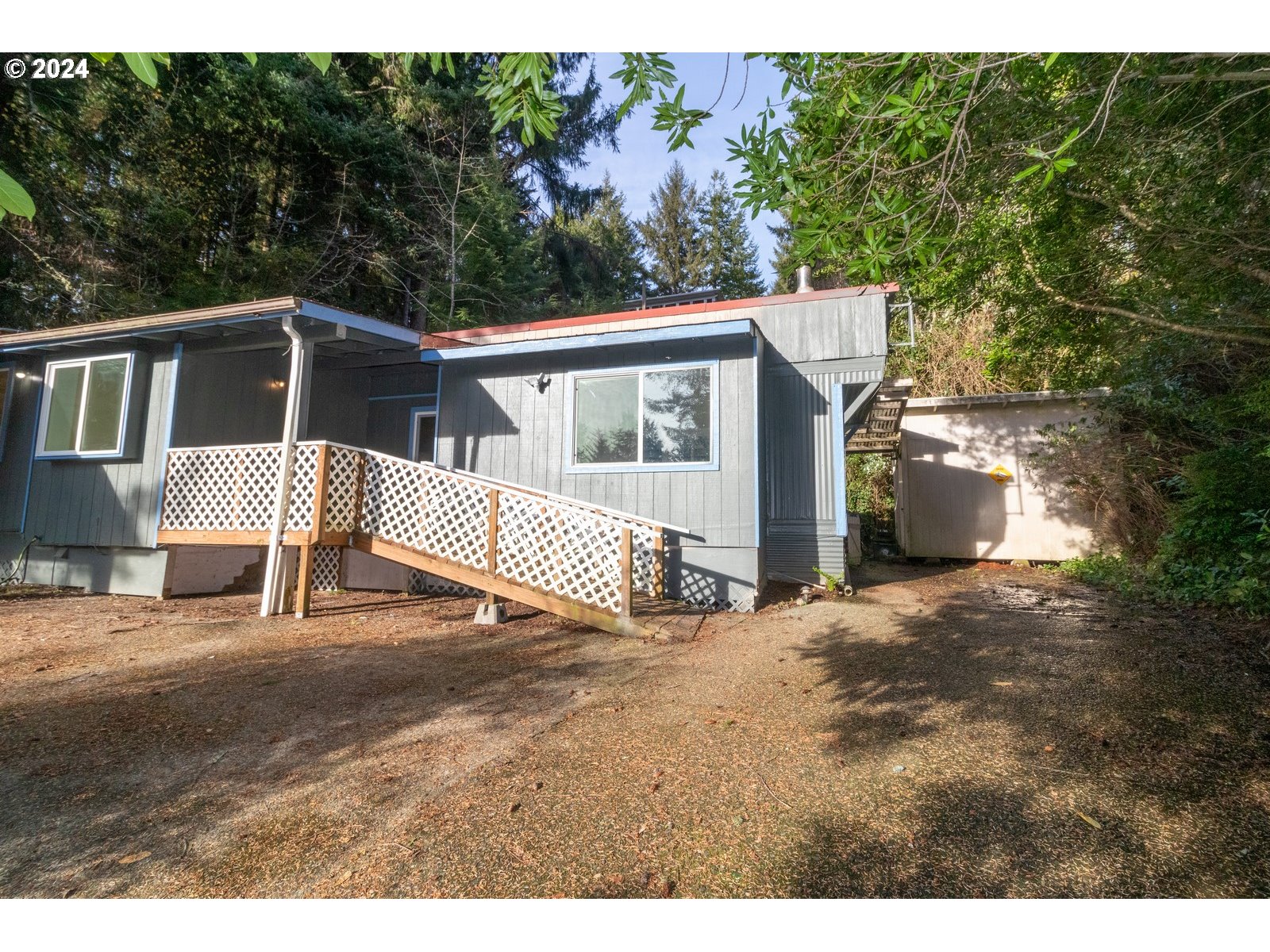 a view of a house with a yard and fence